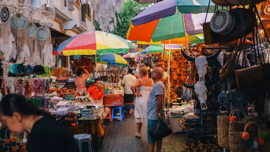 A crisp shot of a vibrant Seminyak shopping street lined with boutique cafes and palm trees.