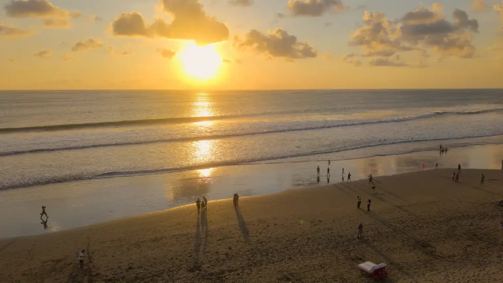 Golden hour sunset view over Seminyak Beach with soft rolling waves